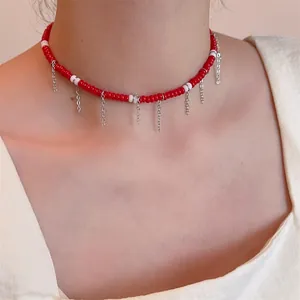 Collier ras du cou perlé rouge et blanc avec de délicates chaînes à pompons argentés