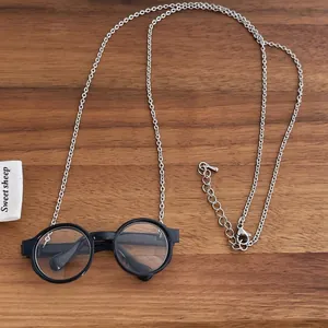 Detail view of retro black round glasses pendant with a fine silver lobster clasp chain