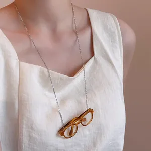 Artistic silver glasses chain necklace featuring vintage amber round frames on a thin link