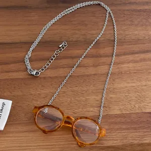 Artistic glasses pendant necklace with orange tortoiseshell frames on silver chain