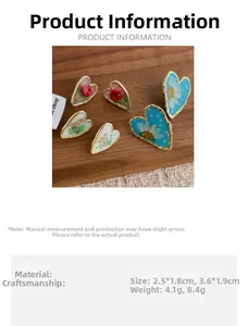 Detail view of heart-shaped dry flower earrings with resin gold foil and size specifications