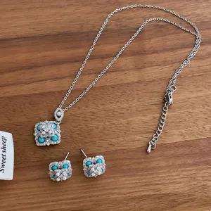 Elegant floral necklace and stud earring set featuring turquoise beads and white pearls