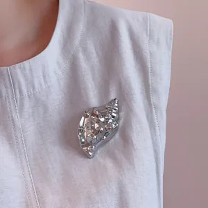 Polished silver conch shell brooch in a luxurious 18K gold plated vintage design