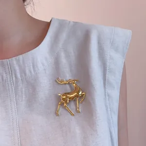 Close-up of golden elk brooch with polished metallic finish on elegant suit lapel