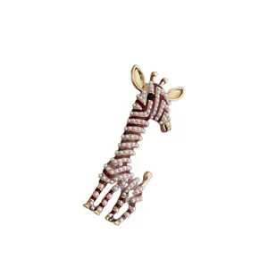 Cute giraffe brooch with white pearls and burgundy enamel details in a gold-tone setting