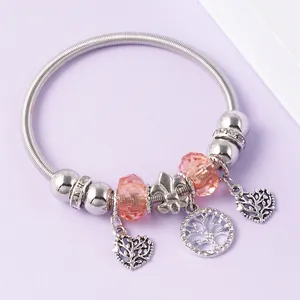 Close-up of silver beaded bracelet with heart charms and orange crystal beads