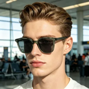 Close-up of green translucent square sunglasses worn by male model in travel setting