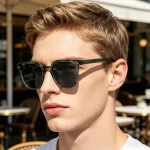 Detail view of retro square dark green sunglasses with silver studs on male model