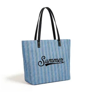 Close-up of blue and white striped canvas texture with Summer text and leather handles