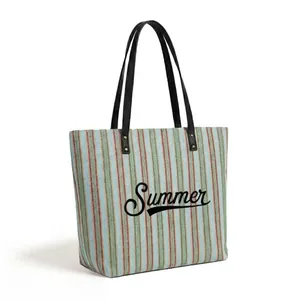Detail of colorful striped woven beach tote bag with black Summer lettering and handles