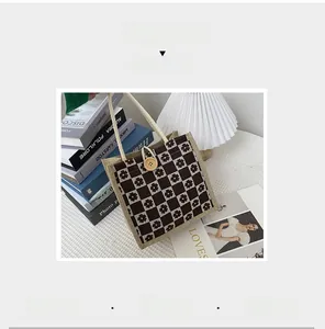 Close-up of linen checkered bag with floral patterns, wooden button, and rope handle