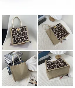 Detail view of mini canvas tote with daisy checkerboard pattern and wooden button closure