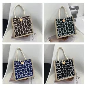 Detail of canvas mini tote bags with floral checkerboard pattern and wooden button