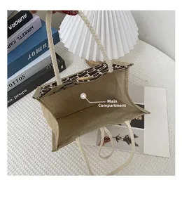 Detailed top view of canvas tote bag showing floral lining and wood button closure