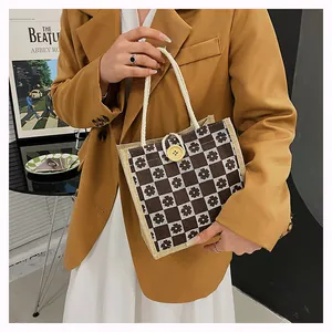 Close-up of floral checkerboard canvas tote with cotton rope handles and yellow button