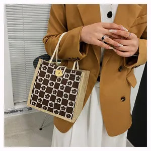 Close-up of small floral checkered canvas tote bag with woven handles and yellow button