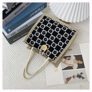 Detail of canvas bento bag featuring floral checkerboard pattern and wooden button