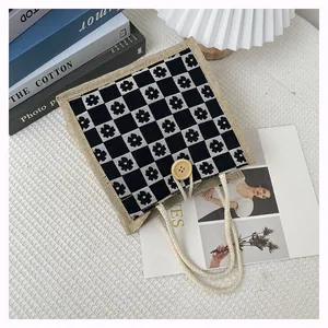 Detail of floral checkerboard burlap handbag with wooden button and braided rope handle