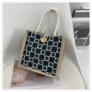 Close-up of floral checkered canvas tote bag with cotton rope handle and wooden button