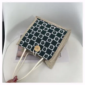 Detailed macro view of the floral checkerboard burlap bag with cotton rope handle and wood button