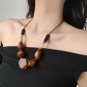 Detailed close-up of a vintage irregular resin bead necklace on a female neck