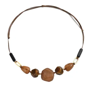 Vintage ethnic irregular brown marble resin necklace with gold metal links on white background