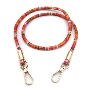 Detailed view of colorful woven phone strap with golden metal lobster clasps