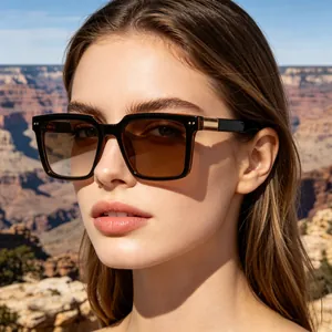 Chic oversized square frame sunglasses with brown lenses worn by a model in outdoor setting