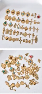 Collection of golden metal charms featuring hearts, crosses, and colorful gemstone accents