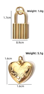 Detail view of golden heart and lock pendants showing specific weight and dimensions