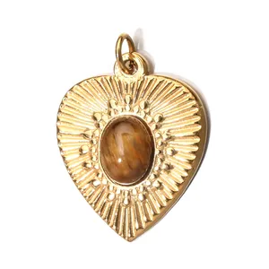 Golden heart pendant with tiger eye stone and vintage engraved radial patterns