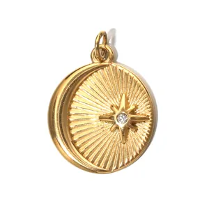 Golden sunburst coin pendant featuring embossed moon and star with crystal stone
