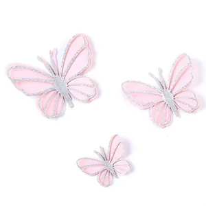 Three-piece set of pink butterfly cake toppers with silver glitter edges in varying sizes