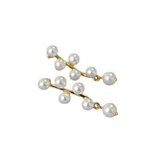 Elegant geometric pearl tassel earrings with gold-plated wavy frame in a minimalist style