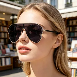 Detail of silver oversized shield sunglasses on a model with futuristic geometric lines