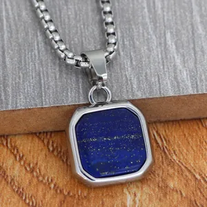 Minimalist stainless steel square lapis lazuli pendant necklace on a textured background