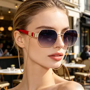 Close-up of stylish women's polygon sunglasses with gold chain and gradient purple lenses