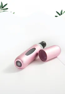 Detail showing the bottom-fill valve and pink matte aluminum spray nozzle of the perfume bottle