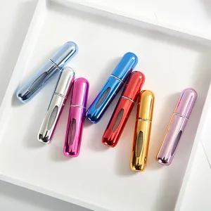 Macro view of portable mini perfume spray bottles in multiple metallic colors with windows