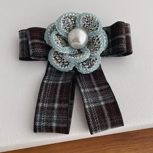 Elegant tweed bow camellia brooch with plaid fabric and pearl accent in center