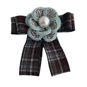 Elegant retro camellia bow brooch with tweed fabric petals and faux pearl center