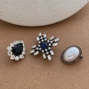 Vintage brooch set with cross, oval pearl, and water-drop crystal designs for suits