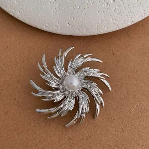 Elegant silver fireworks pearl brooch with a swirling radial design for suit accessories