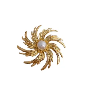 Vintage golden fireworks brooch with a central pearl for elegant suit accessories