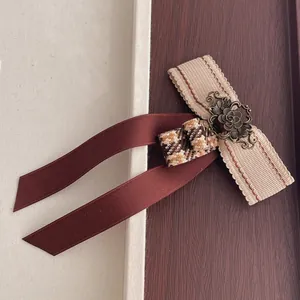 British style coffee brown houndstooth bow brooch with vintage metal flower detail