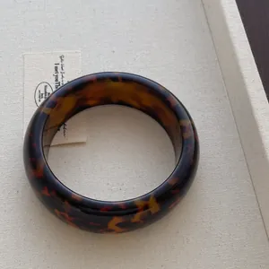 Classic tortoise shell resin wide bangle bracelet with retro minimalist polish finish