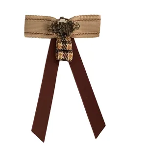 British vintage bow brooch with houndstooth ribbon and antique bronze flower center
