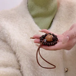 Handmade wooden lion pendant keychain with dark coffee bead mane and leather strap accessory