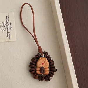 Handcrafted peach wood bear pendant featuring a circle of real roasted coffee beans