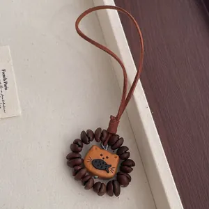 Handmade natural peach wood cat coffee bean pendant on brown suede cord charm